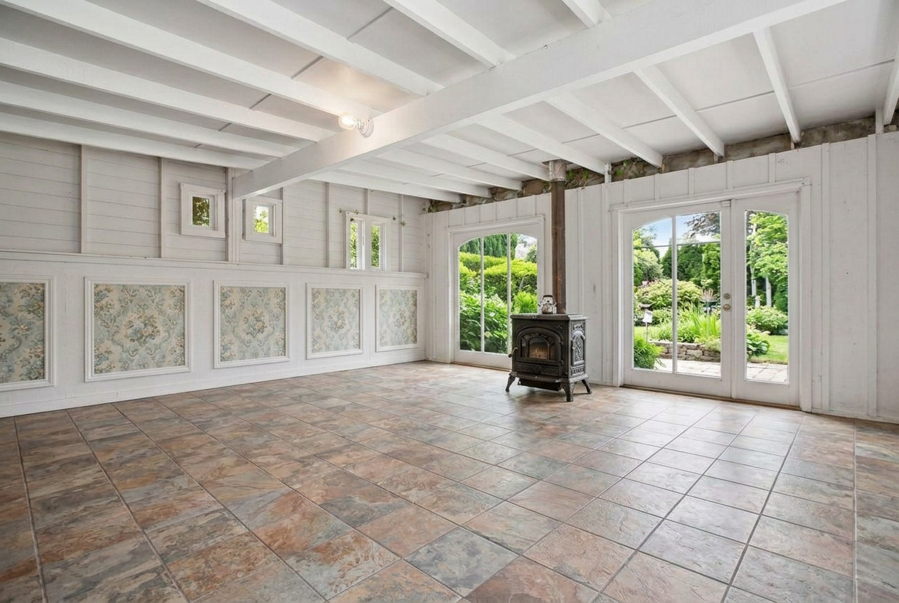 Carriage house interior with Italian wood stove, wallpaper panels and garden doors